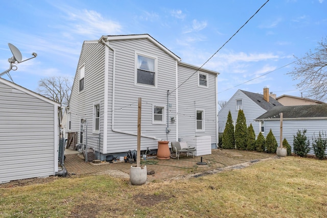 rear view of property featuring a yard and a patio