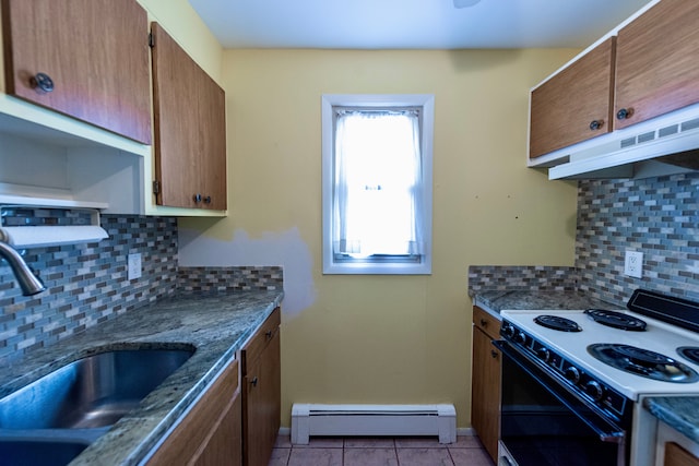 kitchen with electric stove, light tile patterned floors, a baseboard radiator, a sink, and under cabinet range hood