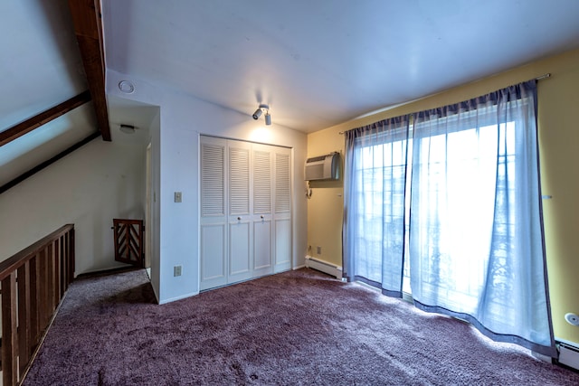 unfurnished bedroom featuring carpet floors, baseboard heating, a wall mounted air conditioner, and a closet