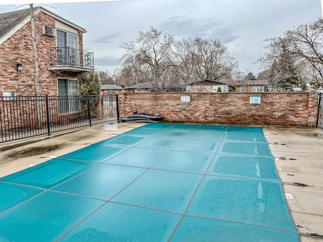 view of pool featuring fence