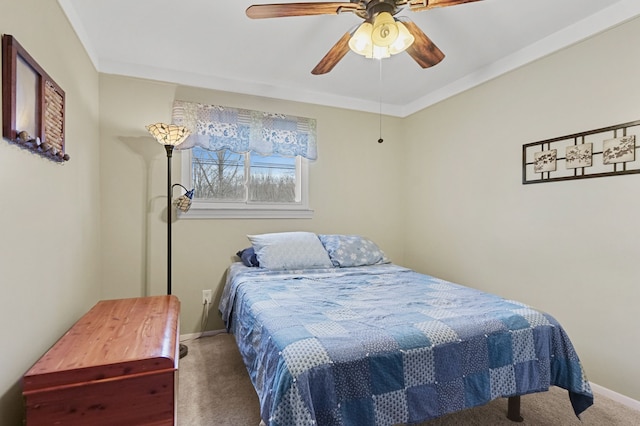 bedroom with carpet, crown molding, baseboards, and a ceiling fan