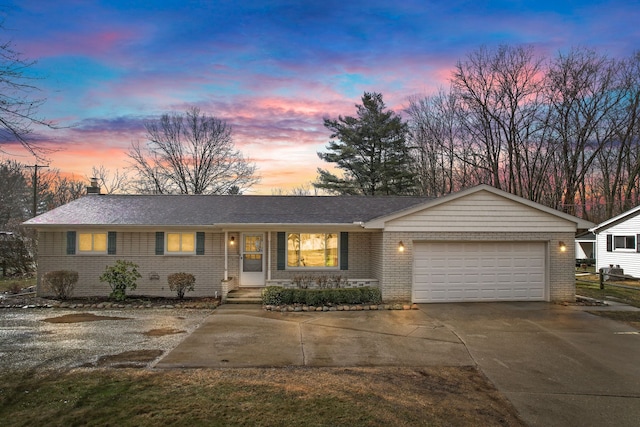 ranch-style house with concrete driveway, brick siding, a chimney, and an attached garage