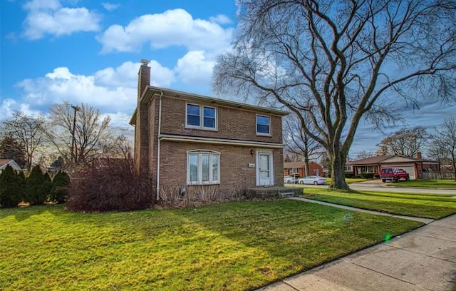 view of front of home featuring a front lawn, brick siding, and a chimney