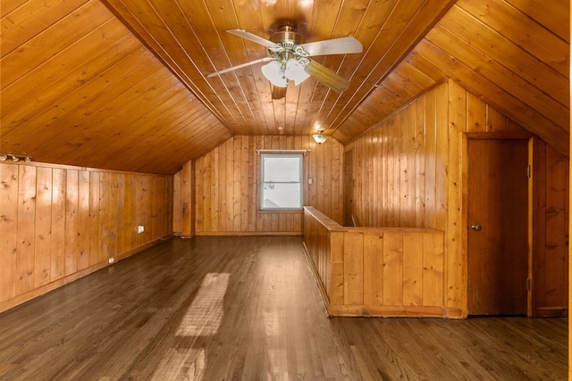 additional living space featuring wooden walls, a ceiling fan, wood finished floors, vaulted ceiling, and wooden ceiling