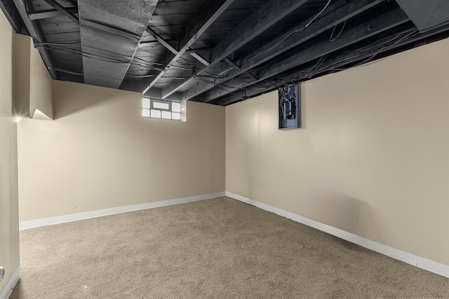 basement featuring baseboards and carpet