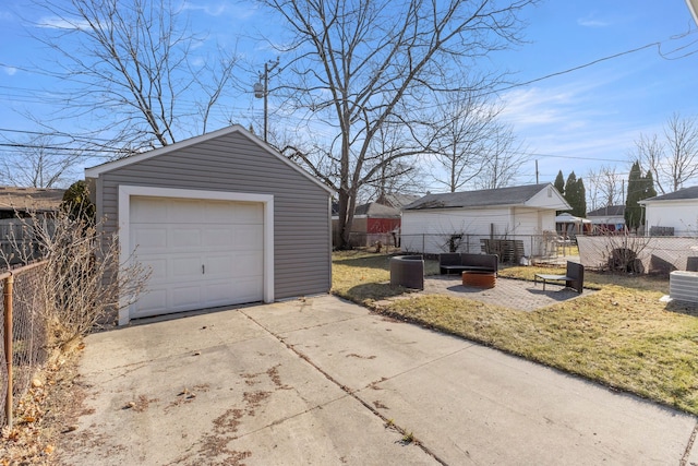 detached garage with driveway and fence