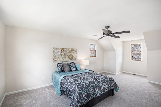 carpeted bedroom with ceiling fan, baseboards, and vaulted ceiling