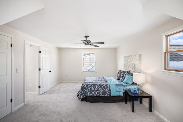 bedroom featuring baseboards, multiple windows, carpet, and ceiling fan