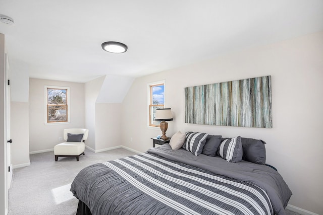 bedroom with baseboards and light colored carpet