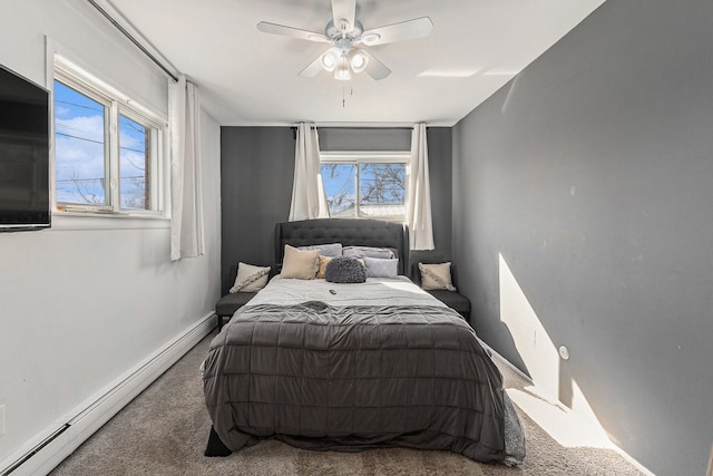 bedroom with a baseboard radiator, baseboards, ceiling fan, and carpet