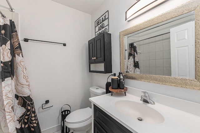 bathroom with curtained shower, vanity, and toilet