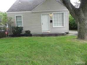 rear view of house with a yard