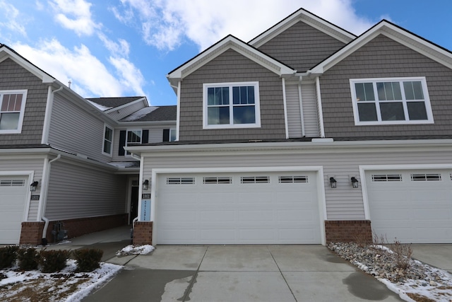 view of front facade featuring a garage, brick siding, and driveway