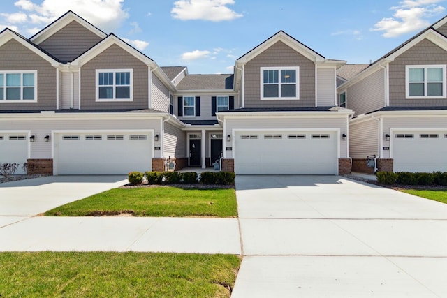 view of front of house featuring a garage, brick siding, and concrete driveway