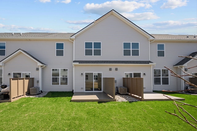 rear view of house with a patio area, a yard, and central AC