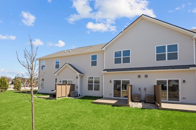 rear view of property with a lawn, central air condition unit, and a patio