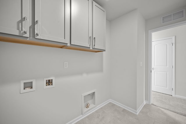 clothes washing area with hookup for a washing machine, hookup for an electric dryer, cabinet space, baseboards, and visible vents