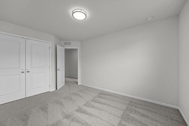 unfurnished bedroom with visible vents, carpet flooring, and baseboards