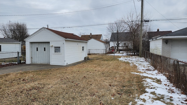 view of yard with an outbuilding, fence, and a detached garage