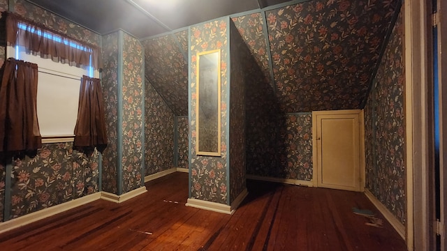 bonus room with baseboards, hardwood / wood-style floors, and wallpapered walls