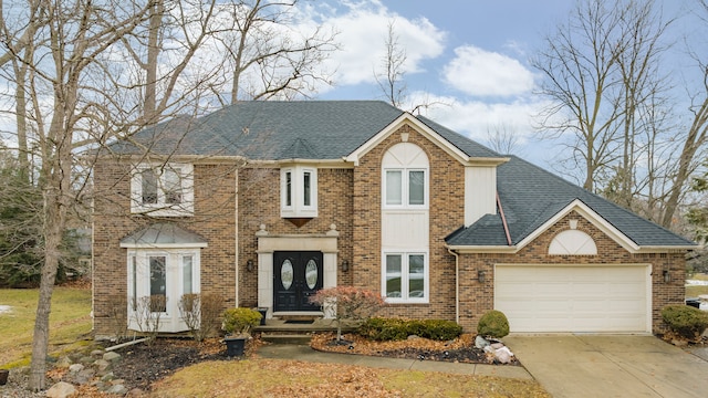 view of front of house featuring french doors, brick siding, a shingled roof, concrete driveway, and an attached garage