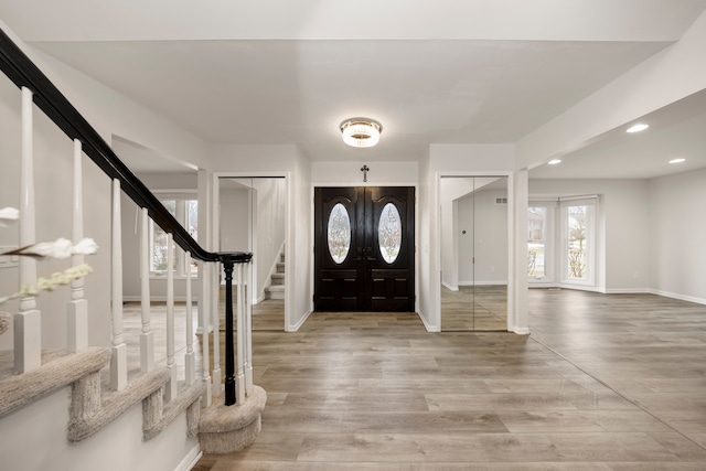 entryway with french doors, recessed lighting, light wood-style flooring, baseboards, and stairs