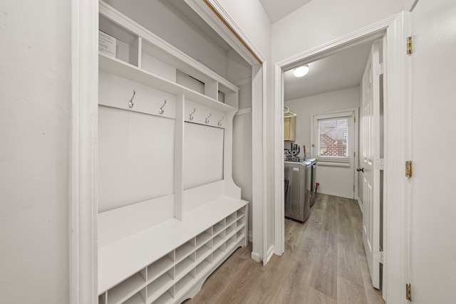 mudroom featuring independent washer and dryer and light wood-style flooring