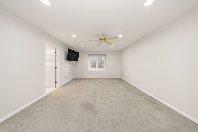 carpeted spare room featuring recessed lighting, ceiling fan, and baseboards