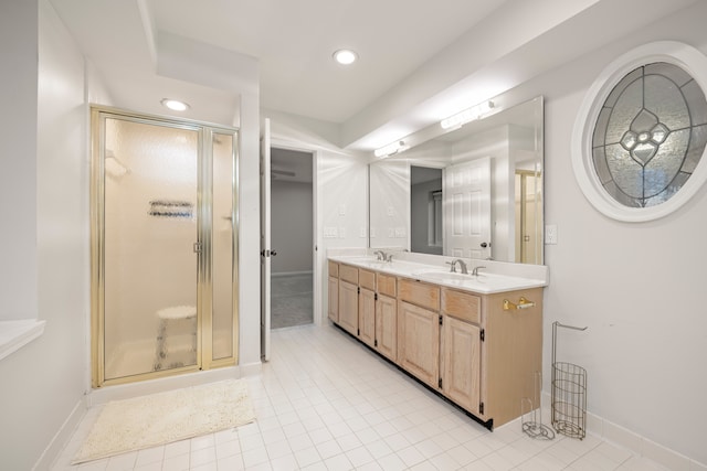 bathroom featuring a stall shower, a sink, recessed lighting, and double vanity