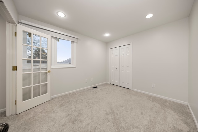 carpeted empty room featuring baseboards and recessed lighting