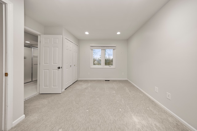 unfurnished bedroom with light carpet, baseboards, and recessed lighting