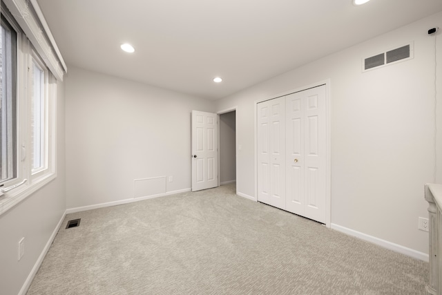 unfurnished bedroom featuring carpet floors, visible vents, and recessed lighting