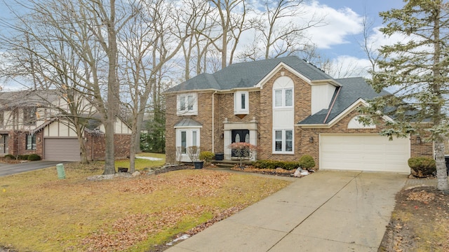 view of front of property with brick siding, roof with shingles, concrete driveway, a front yard, and a garage