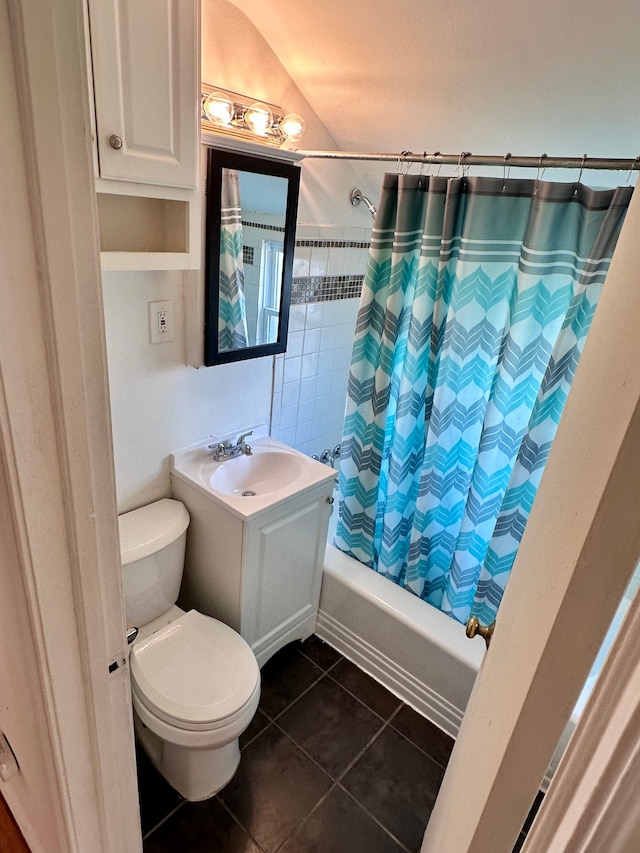 full bath featuring shower / bath combination with curtain, a sink, toilet, and tile patterned floors