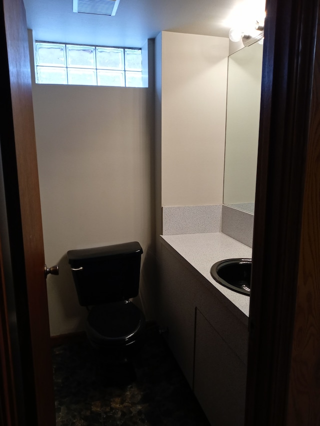 bathroom with toilet and vanity