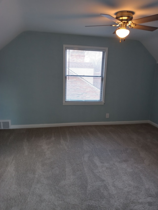 additional living space featuring carpet, lofted ceiling, visible vents, a ceiling fan, and baseboards