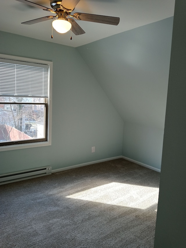 bonus room with a baseboard heating unit, carpet floors, a ceiling fan, baseboards, and vaulted ceiling