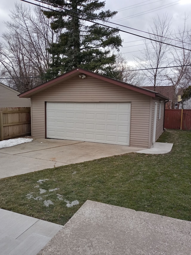 detached garage featuring fence