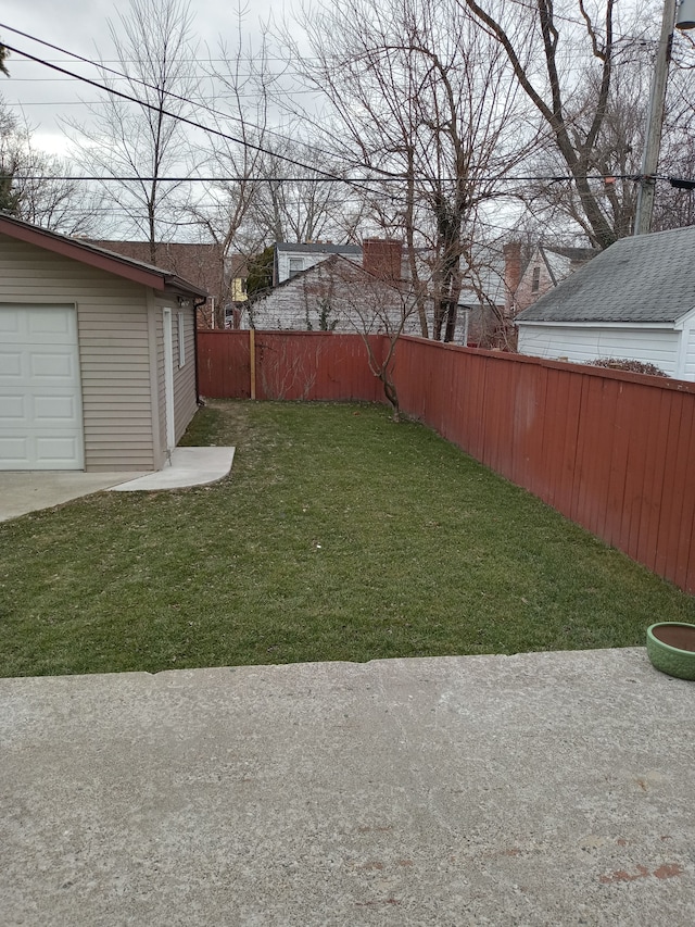 view of yard with an outbuilding and a fenced backyard