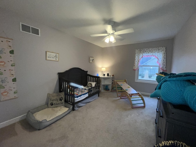 carpeted bedroom featuring baseboards, visible vents, and a ceiling fan