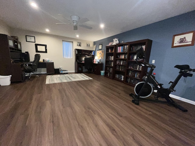 office space with a ceiling fan, baseboards, and wood finished floors