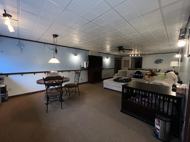 bedroom featuring carpet, a fireplace, and baseboards