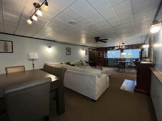 carpeted living room with ceiling fan