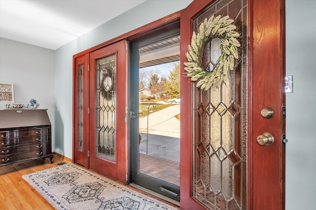 entryway featuring baseboards and wood finished floors