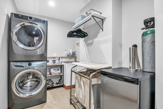 washroom featuring laundry area and stacked washer / drying machine