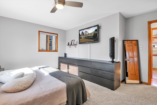 carpeted bedroom with a ceiling fan and baseboards