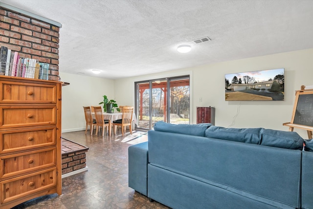 living room with baseboards, dark floors, visible vents, and a textured ceiling