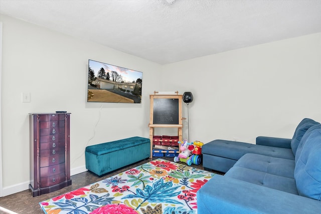 living room featuring baseboards and a textured ceiling