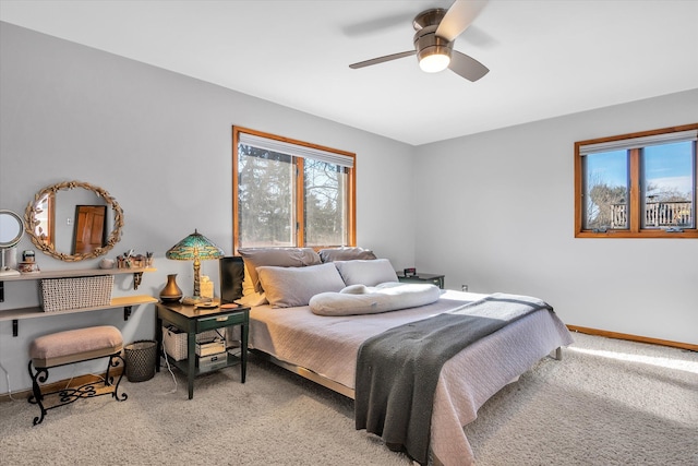 carpeted bedroom featuring ceiling fan and baseboards