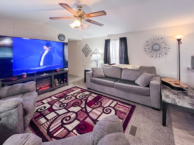 carpeted living area featuring a ceiling fan and lofted ceiling